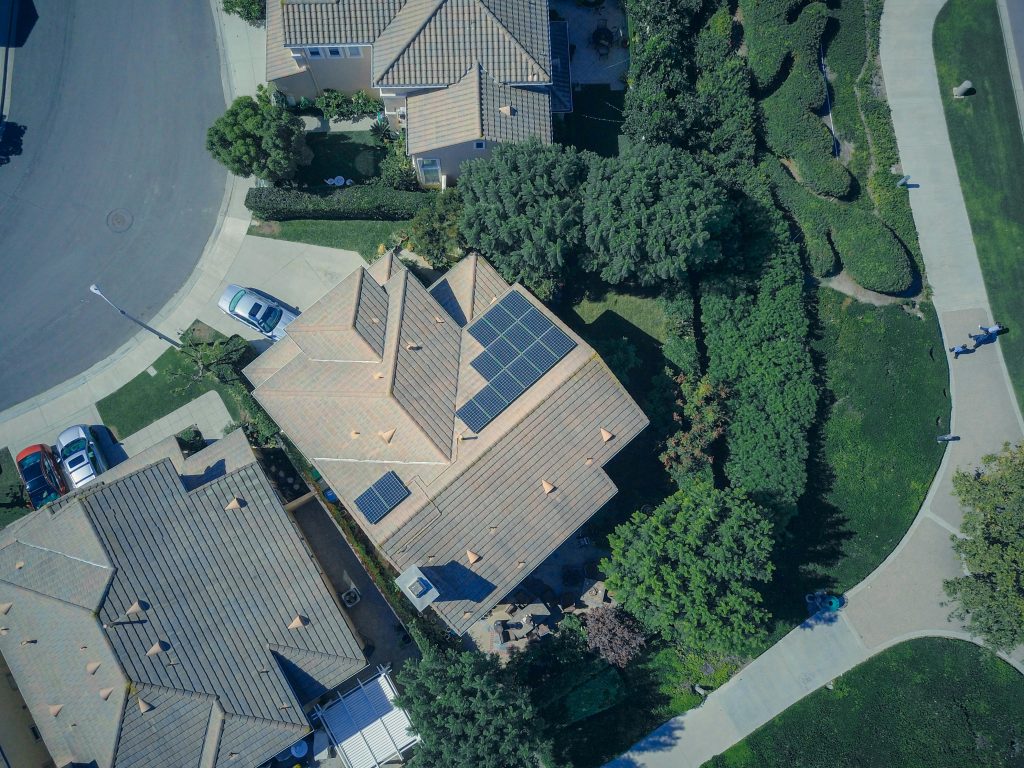 An aerial view showcasing modern suburban houses equipped with solar panels for renewable energy.
